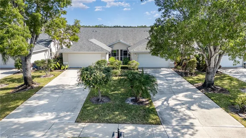 View of front of home with a garage and a front lawn