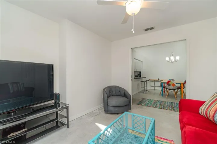 Bedroom with concrete floor and slider doors