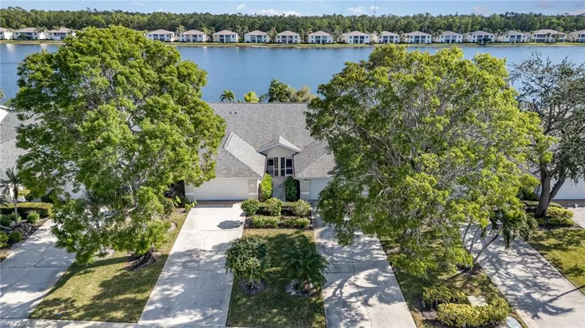View of property with a lake view