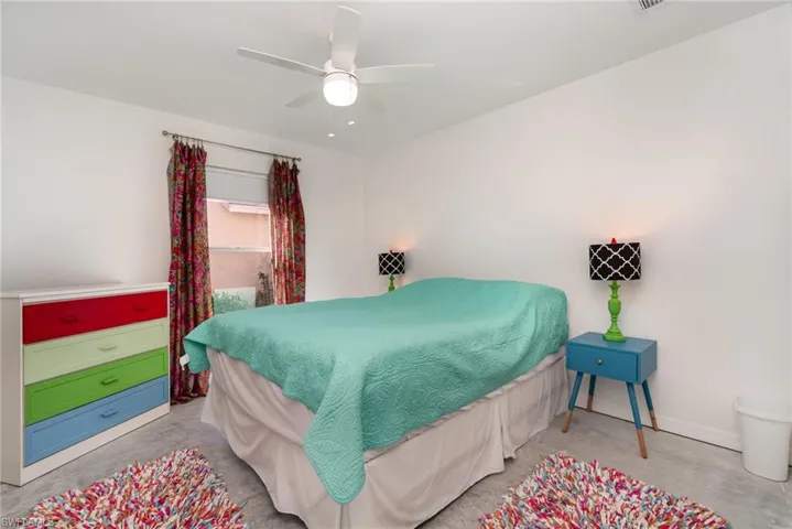 Guest Bedroom with concrete floor and private door to guest bathroom