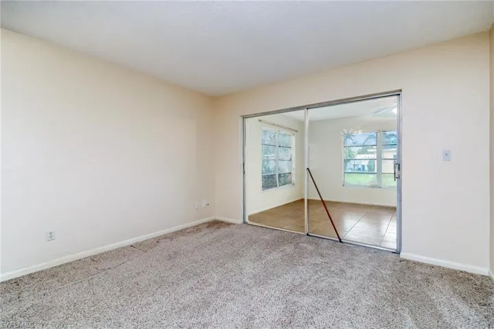 Unfurnished bedroom featuring carpet and a closet