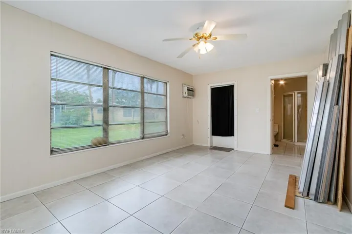 Spare room with a ceiling fan and light tile patterned flooring