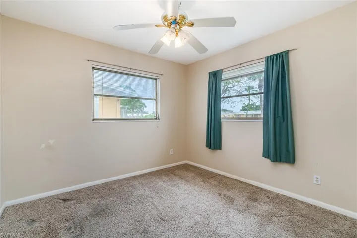 Unfurnished room featuring carpet and ceiling fan