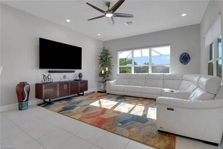 Spacious family room with abundant windows and a door leading to the lanai