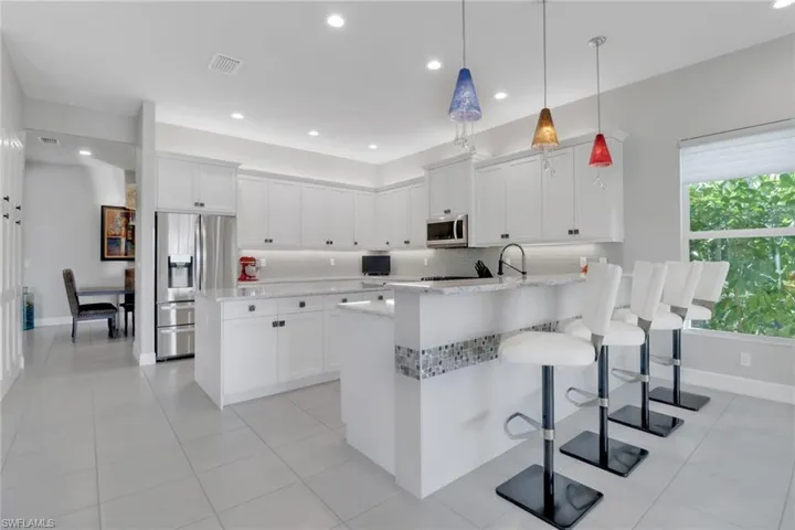 Gourmet kitchen with spacious island, eat-at countertops, and abundant pull-out drawers
