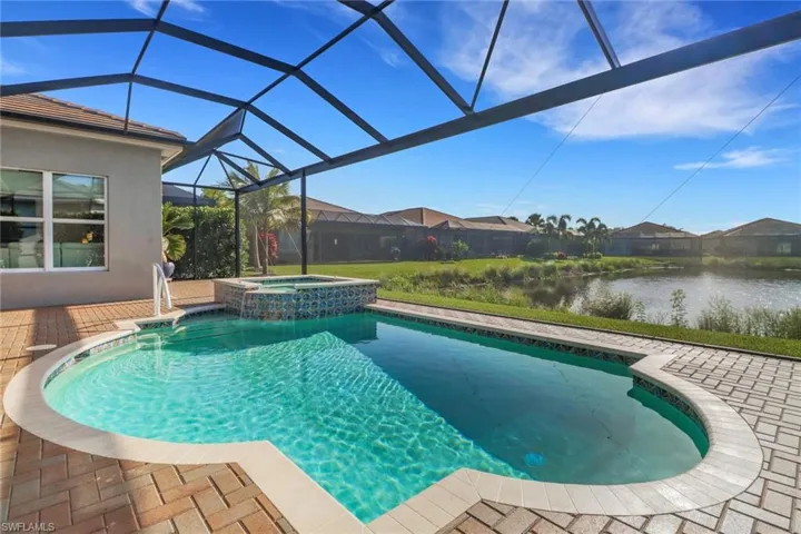 Saltwater pool and spa framed by a panoramic picture window screen with tranquil lake views