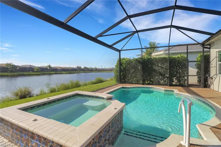 Saltwater pool and spa framed by a panoramic picture window screen with tranquil lake views