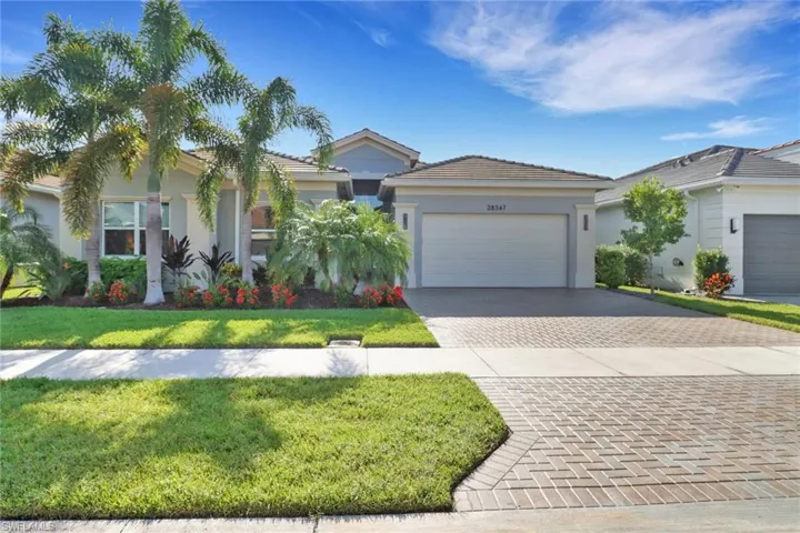 Front of home with fresh landscaping and sealed pavers