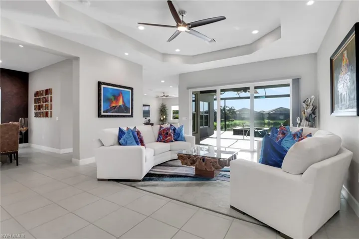 Open living room with beautiful views of the pool and tranquil lake beyond