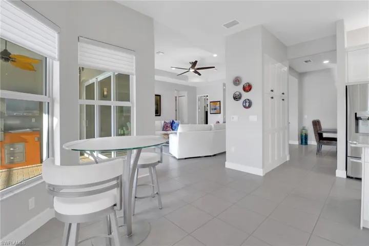 Casual eating area adjacent to a pantry featuring two cabinets with convenient pull-out storage