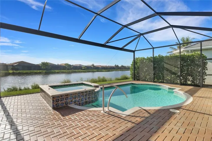 Saltwater pool and spa framed by a panoramic picture window screen with tranquil lake views