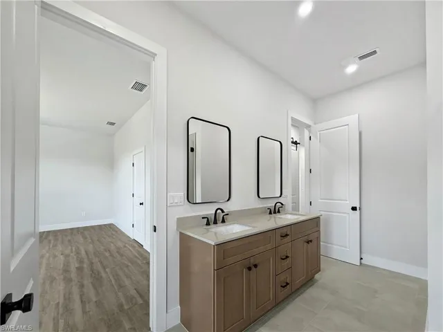 Primary Ensuite bath with double vanity and recessed lighting