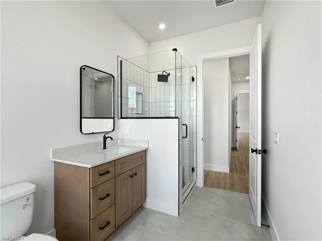 Bathroom 2 featuring vanity, a stall shower, and light tile patterned flooring
