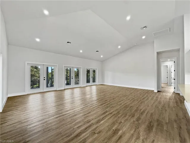 Great Room/Living Room featuring French doors, recessed lighting, and high vaulted ceiling