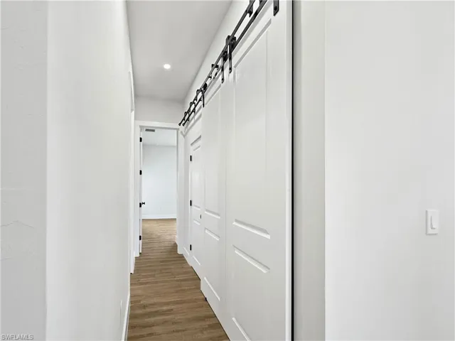 Corridor with a barn door to laundry/storage