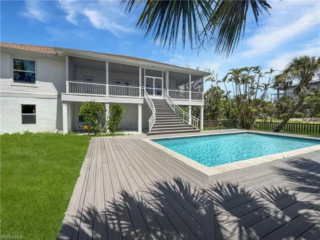 Swimming pool featuring stairway, a patio area, and a composite "wood" deck