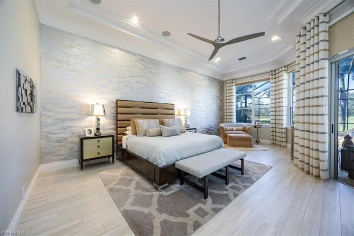 Bedroom with wallpapered walls, access to outside, light wood-type flooring, ornamental molding, and a ceiling fan