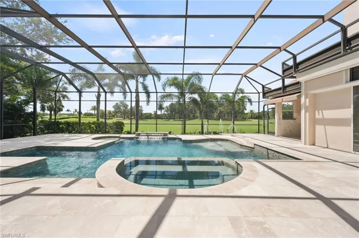 View of pool with a sunroom, a patio, a pool with connected hot tub, and a lanai