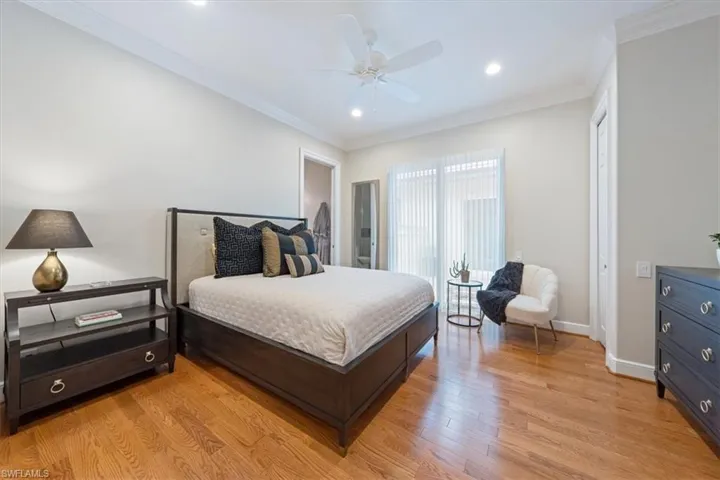 Bedroom with crown molding, light wood-style floors, a ceiling fan, and recessed lighting