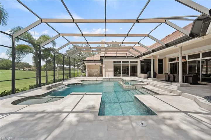 View of pool with a sunroom, a patio, a pool with connected hot tub, and a lanai