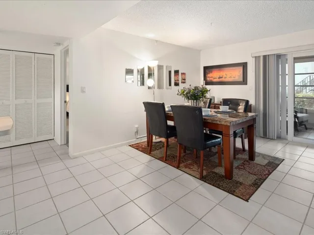 Dining area with light tile patterned floors