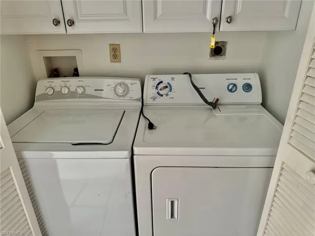 Laundry room with cabinet space and washing machine and dryer