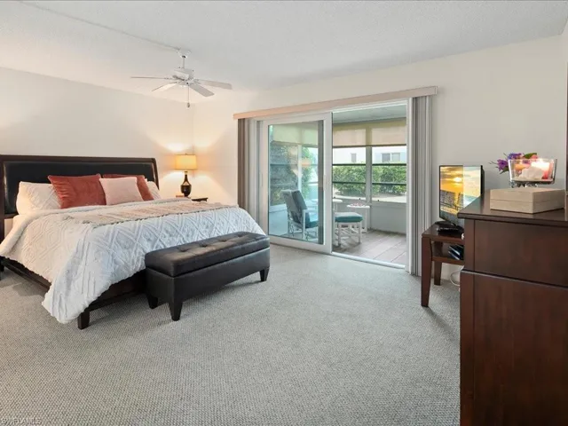 Very spacious bedroom featuring access to exterior and a ceiling fan