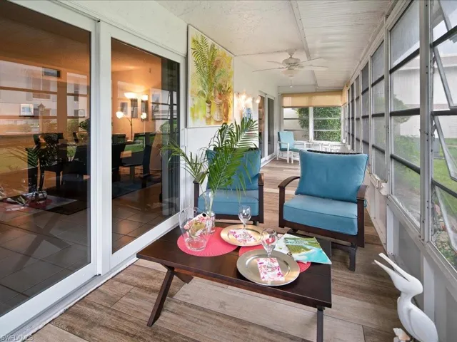 Sunroom featuring a ceiling fan
