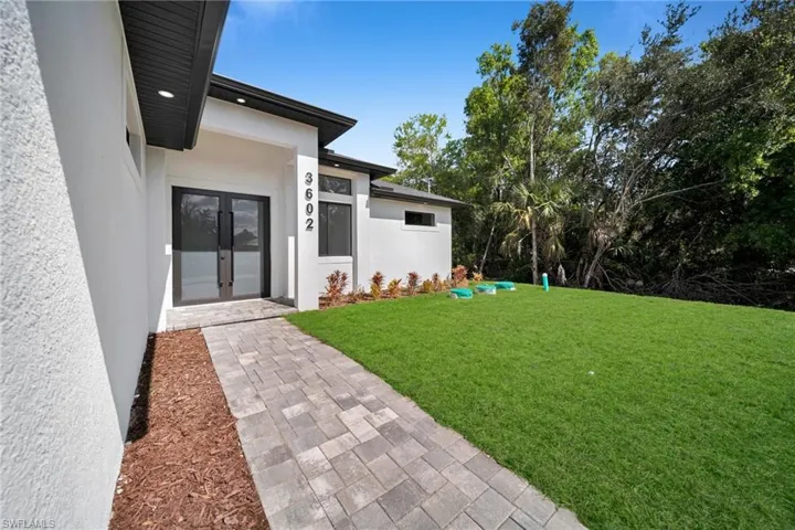 View of grassy yard with french doors
