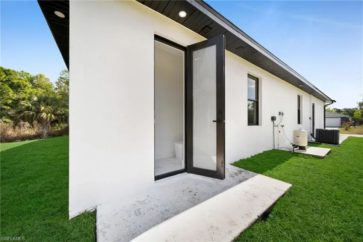View of home's exterior with a yard, stucco siding, and a patio