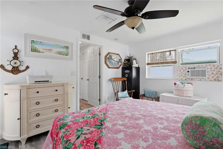 Bright interior with a ceiling fan, multiple windows, and LVP flooring