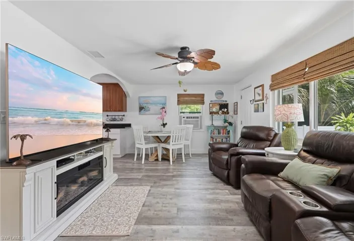 Open concept living area featuring LVP flooring and a ceiling fan