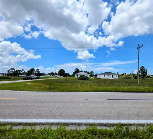 Expansive CORNER-LOT undeveloped land featuring a cleared, level building site