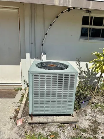 Exterior view of a central AC unit and a fire pit