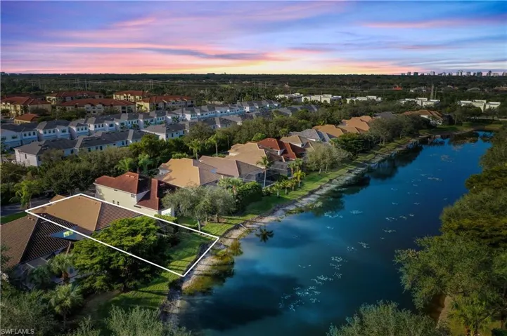 Aerial view at dusk featuring a water view