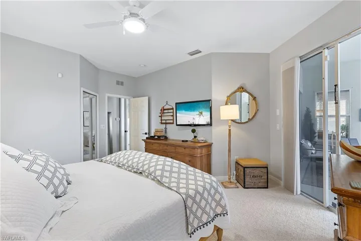 Bedroom with ceiling fan, access to exterior, and light carpet