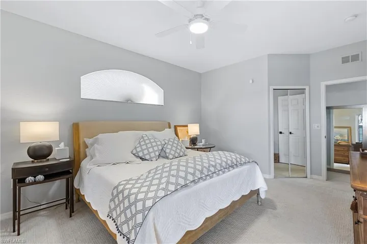 Carpeted bedroom with ceiling fan