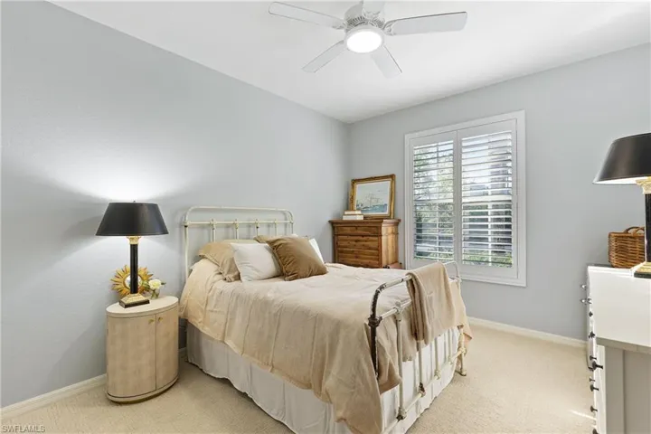Carpeted bedroom featuring ceiling fan