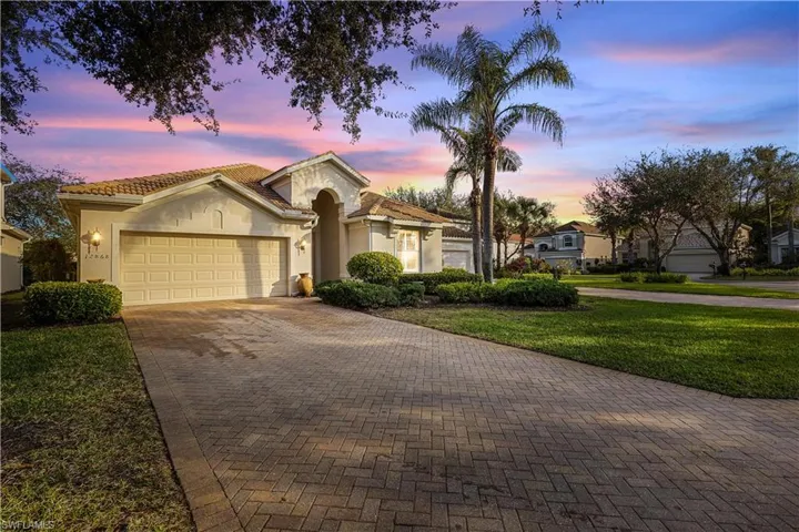 View of front of home featuring a lawn and a garage