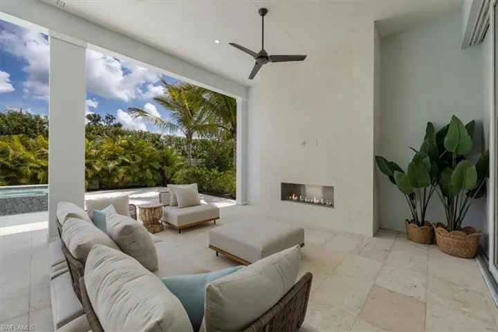 Outdoor living at its finest! Natural gas fireplace, motorized roll-down storm and bug screens, and a heated saltwater pool and spa complete this private outdoor haven.