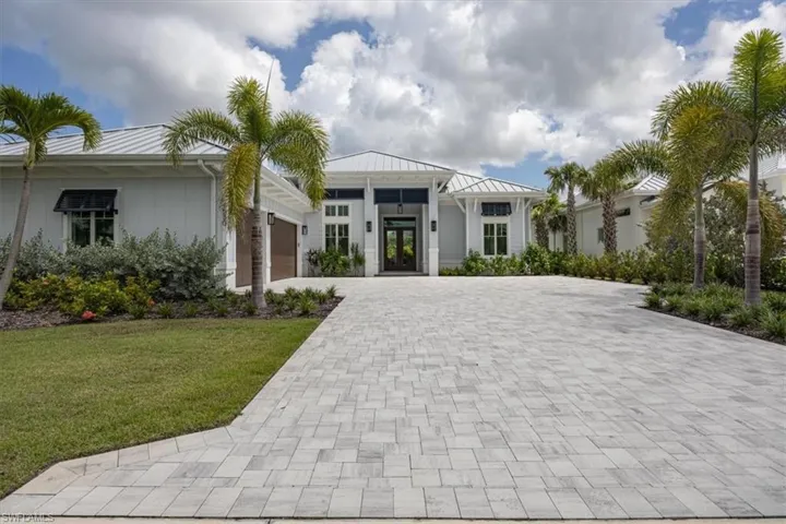 Welcome to 4530 Seagrove Landing Way! Exterior features include a 3-car garage, paver driveway, standing seam metal roofing, decorative Bahama shutters, and all impact doors and windows. A natural gas Generac generator has been added to the side of the home.