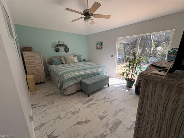 Bedroom with light marble finish flooring, access to exterior, and ceiling fan