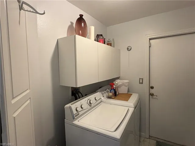 Laundry area featuring cabinet space and separate washer and dryer