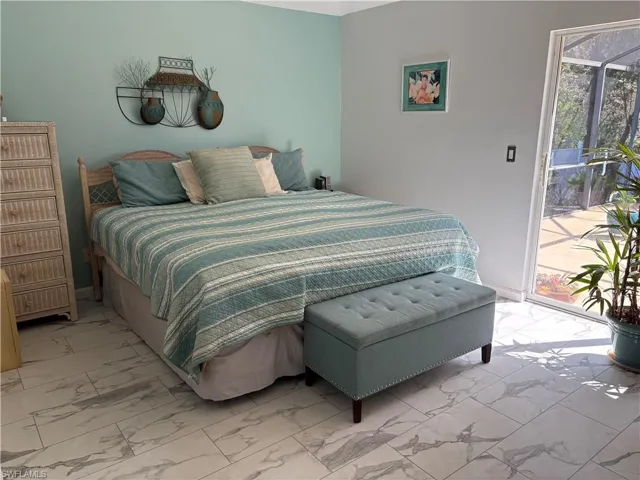 Bedroom featuring access to exterior and light marble finish floors