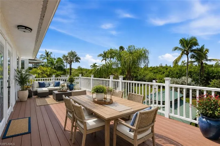 Large Deck off of the Primary Suite, Furniture added and is virtually staged.