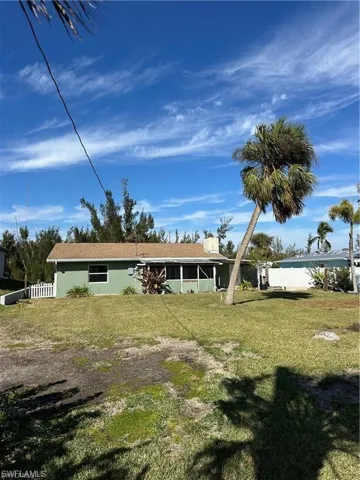 Rear view of property featuring a sunroom