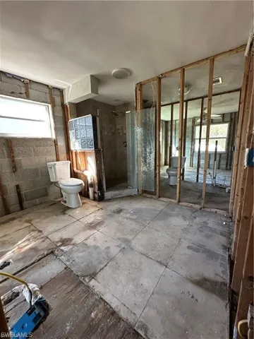 Bathroom featuring healthy amount of natural light and a stall shower