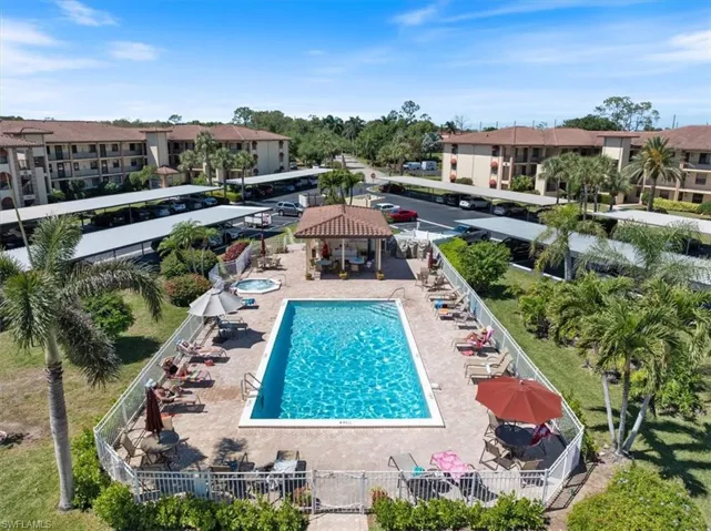 Community pool with a gazebo, a residential view, a patio, and fence