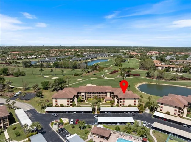 Birds eye view of property featuring a water view and golf course view