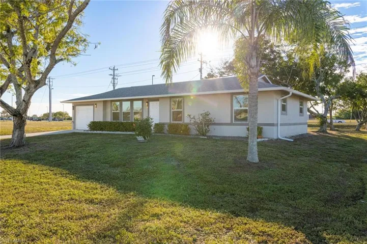 Single story home with a front lawn and a garage